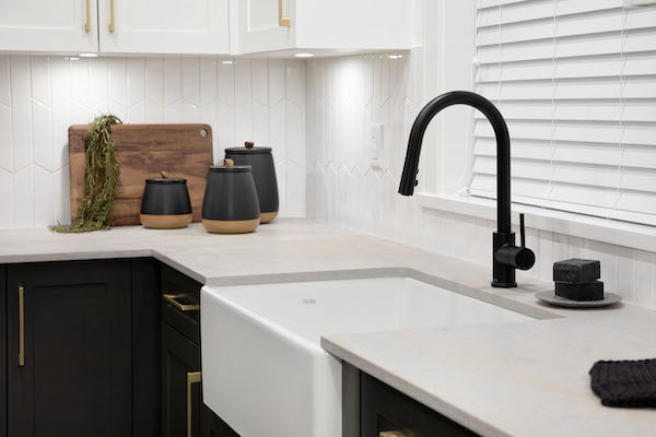 photo of a black kitchen faucet in a spacious modern townhouse kitchen
